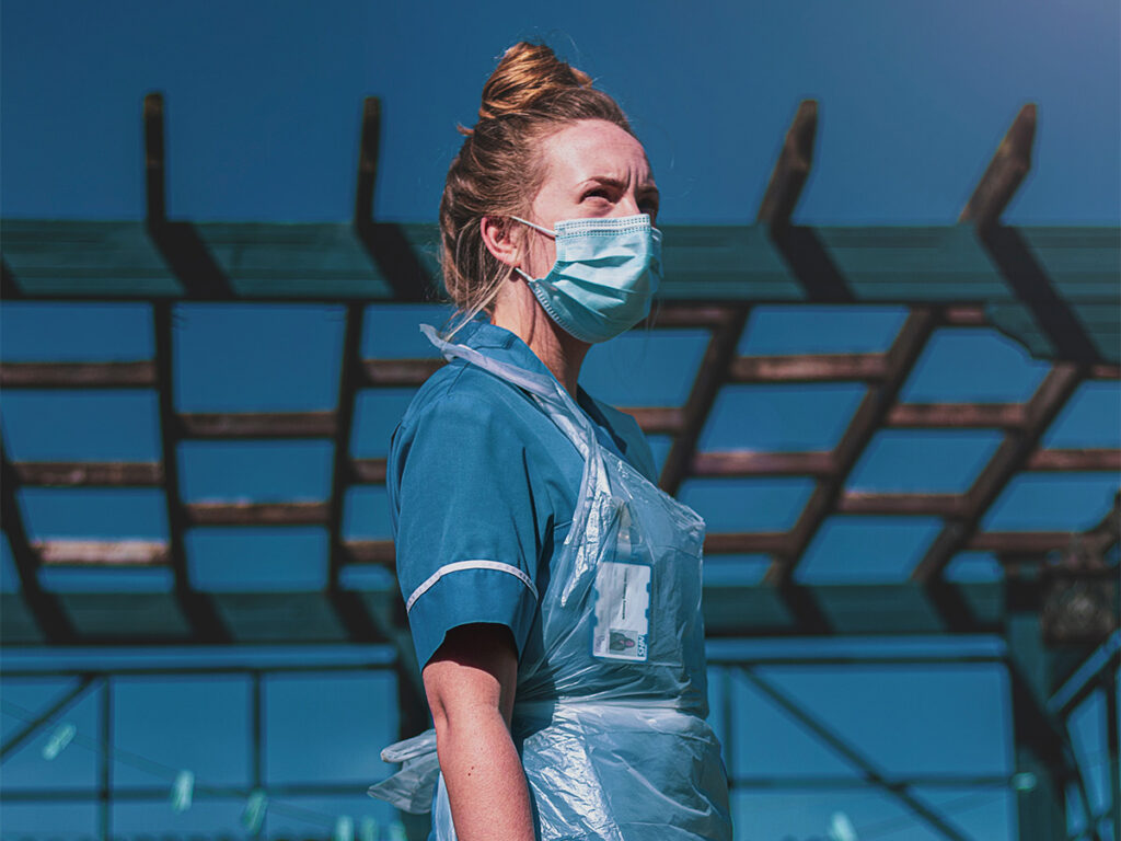 Nurse standing outside with mask on