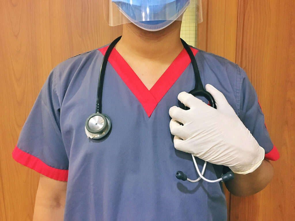 nurse holding on to stethoscope 