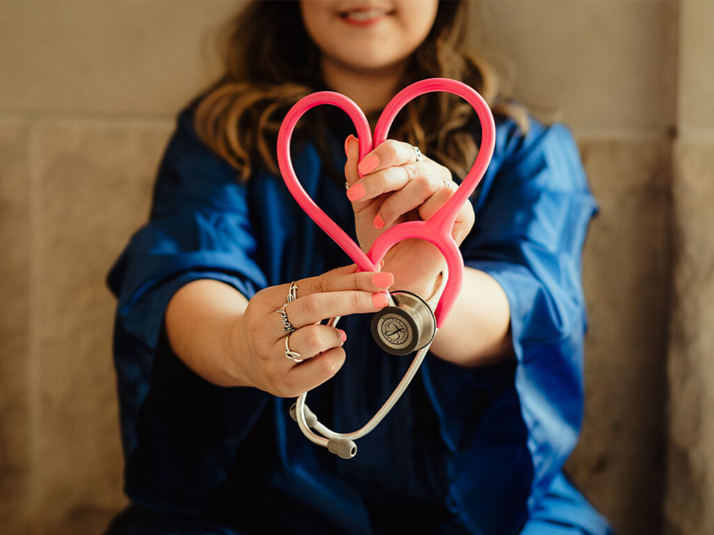 A nurse forming a heart with her stethoscope tubing