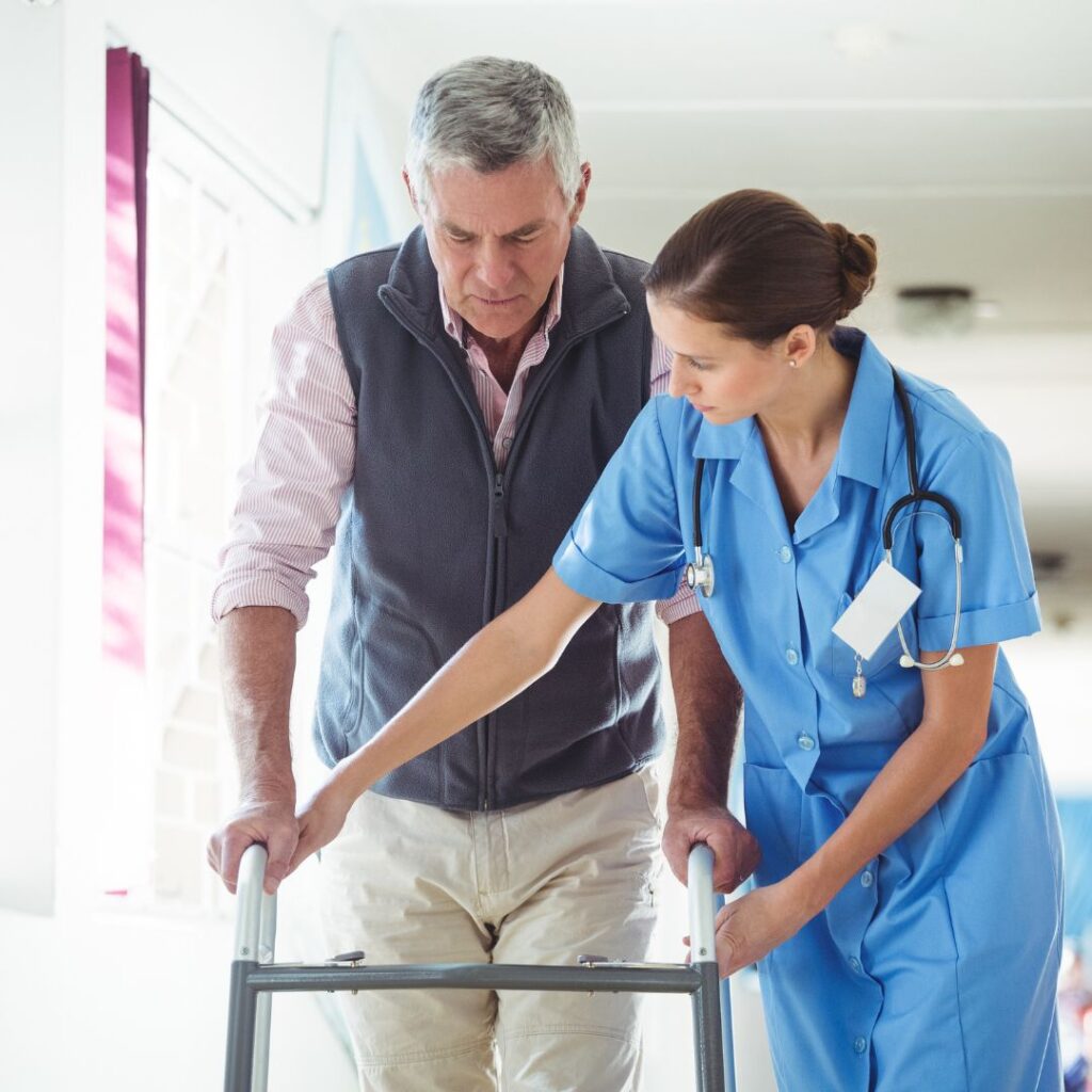 nurse helping man with walker