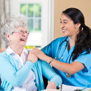 a nurse and client laughing together