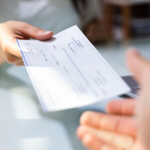 a person being handed a paycheck