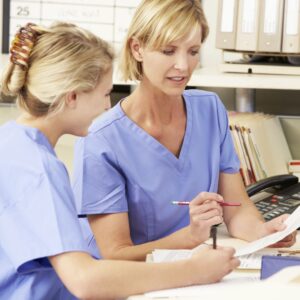 two nurses working on paperwork
