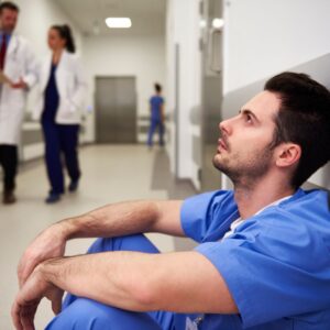male medical staff sitting on floor