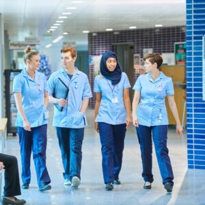 a group of nurses walking and talking together