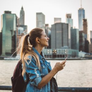 woman exploring city while listening to music
