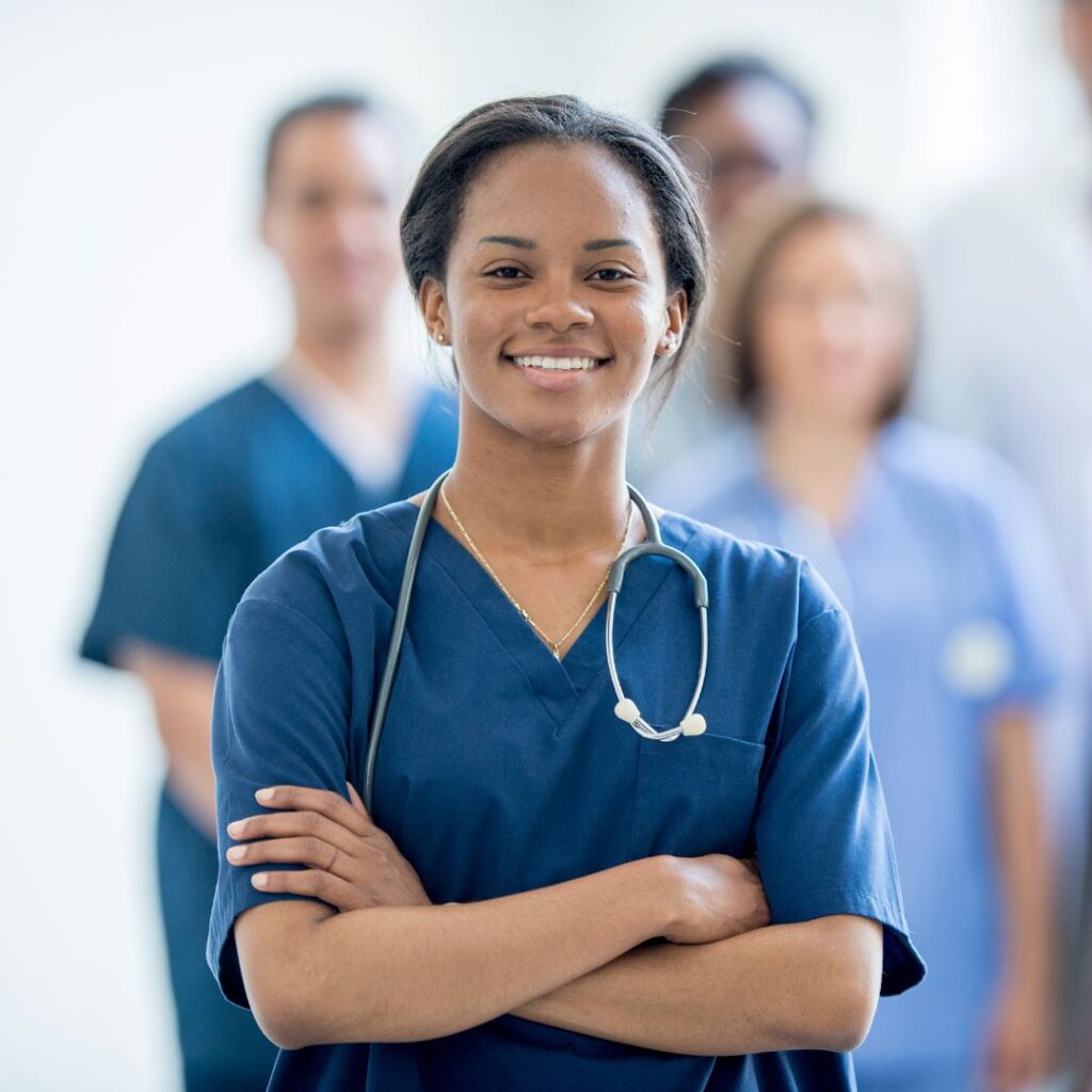 Female nurse standing in front of a group of nurses. 