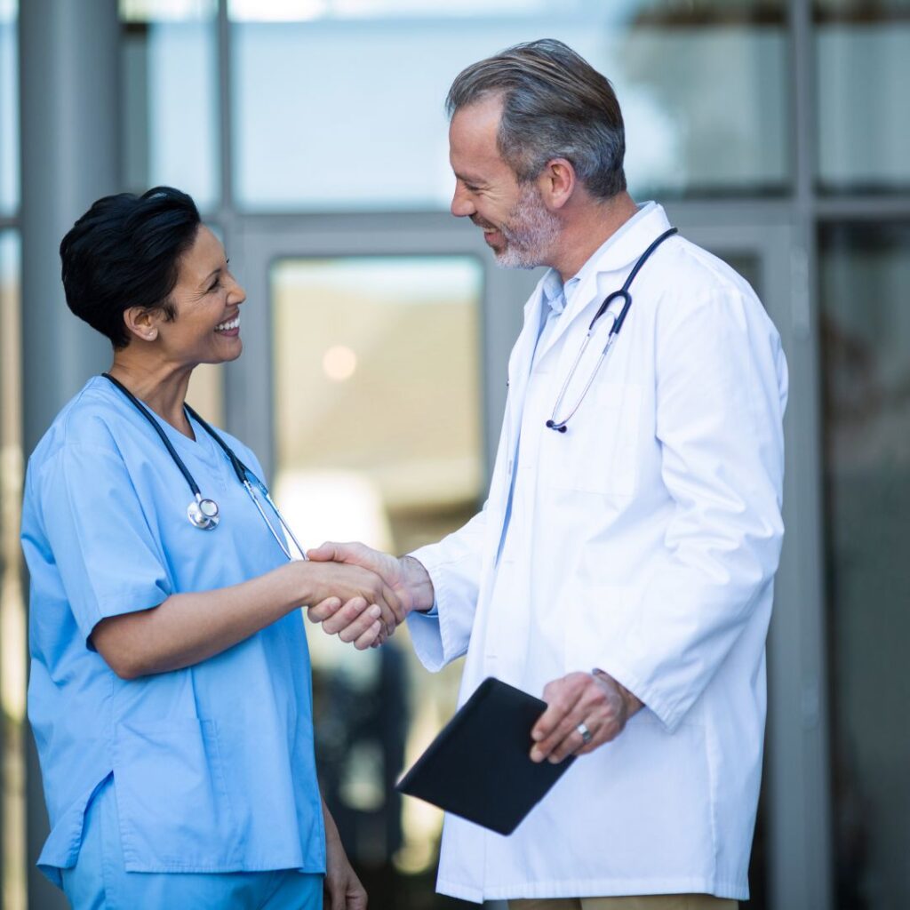 nurse shaking hands with a doctor
