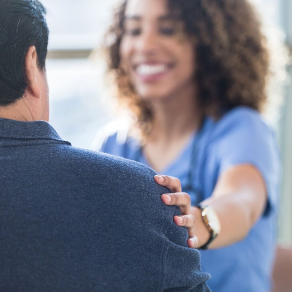 nurse comforting a patient