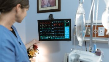 Nurse looking over a patient